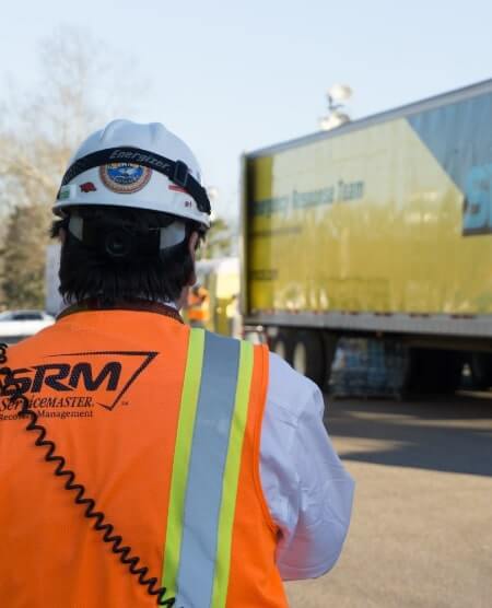 SRM technician in front of truck.
