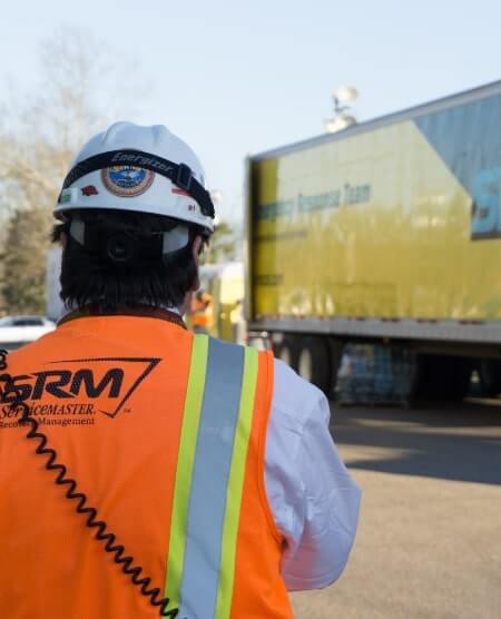 SRM technician in front of truck. 