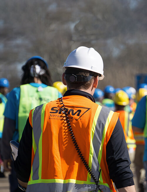 SRM technicians walking onto site.