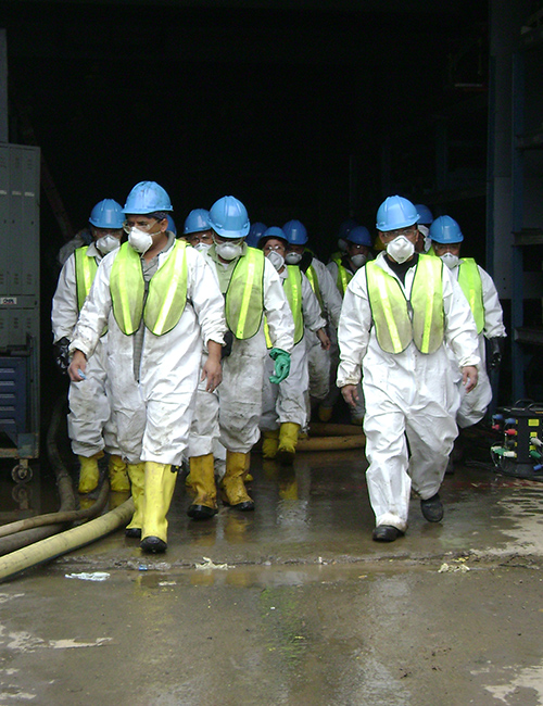 SRM technicians walking at flood site.