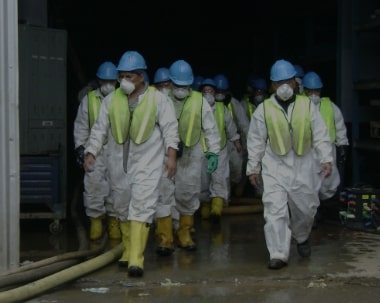 ServiceMaster Recovery Management employees in protective gear headed to a job site