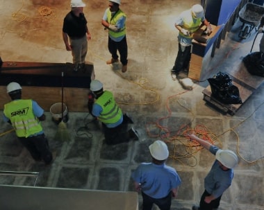 ServiceMaster Recovery Management employees restoring the floor of a business